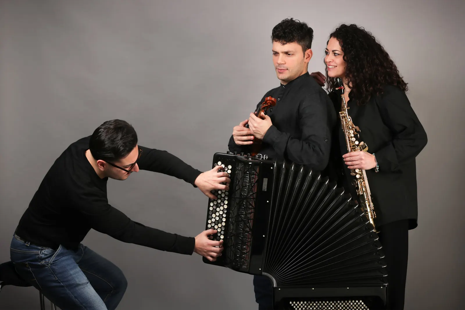 Trio Choré: Luigi Gordano opening the accordion bellows beside violinist Alessandro Acri and saxophonist Marina Notaro